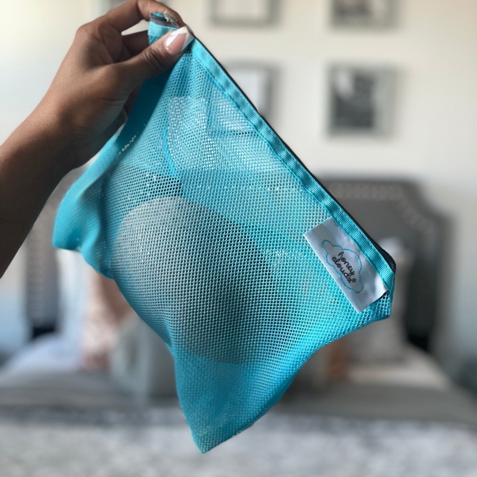 woman holding a delicates washing bag Honey Cloudz Bra inserts wash bag